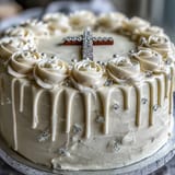 Elegant First Communion Cake with white roses and cross topper, perfect for a sacred celebration