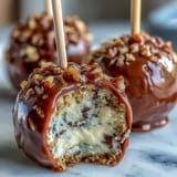 Festive graduation cake pops in school colors, topped with shimmering gold sprinkles for a celebratory dessert display.