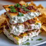 Creamy Cinco de Mayo Loaded Queso Dip with spicy chorizo and fresh pico de gallo, served bubbling hot with crispy tortilla chips.  