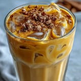 Creamy Turmeric Golden Milk Iced Latte, a calming, spiced dairy-free drink over ice.