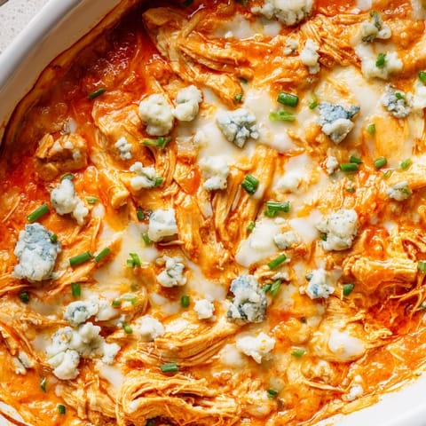 Cheesy, spicy buffalo chicken dip fresh from the oven, perfect for parties.
