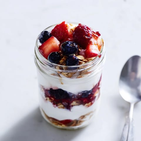 Crumbled granola and sweet berries top this easy Berry Parfait, ready for a healthy breakfast.