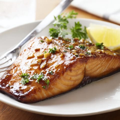 Caramelized Honey Garlic Glazed Salmon fresh from the oven, flaky interior, sticky garlic honey sauce, ideal with steamed rice or roasted veggies.