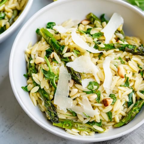 This spring Asparagus Lemon Orzo Salad features crisp shaved asparagus, chewy orzo, and toasted pine nuts, finished with fresh herbs and lemon zest.