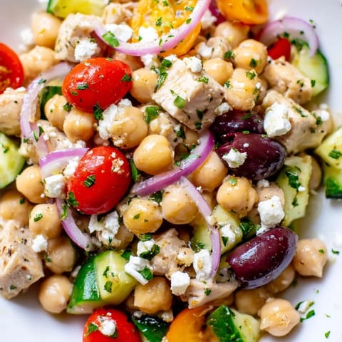 This Mediterranean Chickpea Chicken Salad features juicy chicken, creamy feta, crisp cucumbers, and briny Kalamata olives tossed in a zesty lemon dressing.  