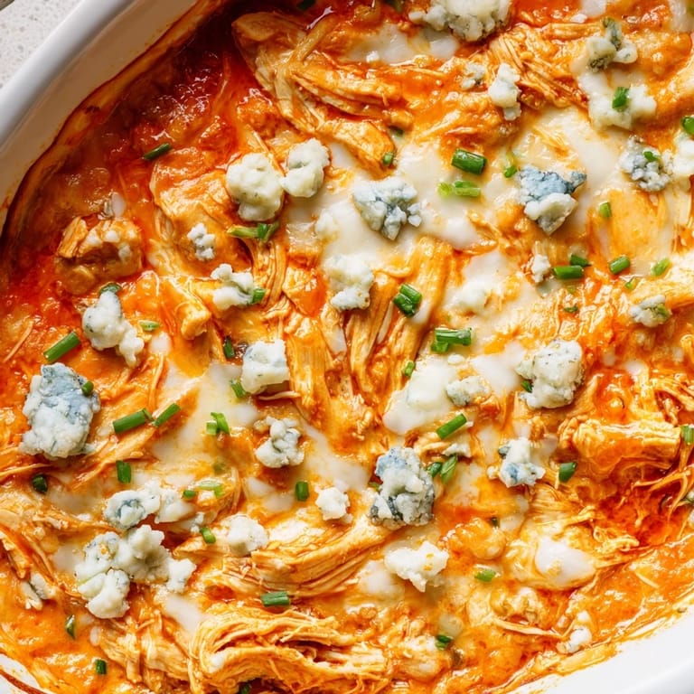Cheesy, spicy buffalo chicken dip fresh from the oven, perfect for parties.