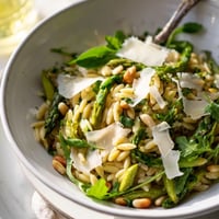 Bright shaved asparagus ribbons and tender orzo pasta are tossed with Parmesan and a zesty lemon-olive oil dressing in this vibrant Asparagus Lemon Orzo Salad.